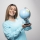 Blonde girl in blue sweatshirt holding a globe, guessing location and having fun. High quality photo