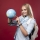 Blonde studentgirl holds a globe and pointing a place. High quality photo